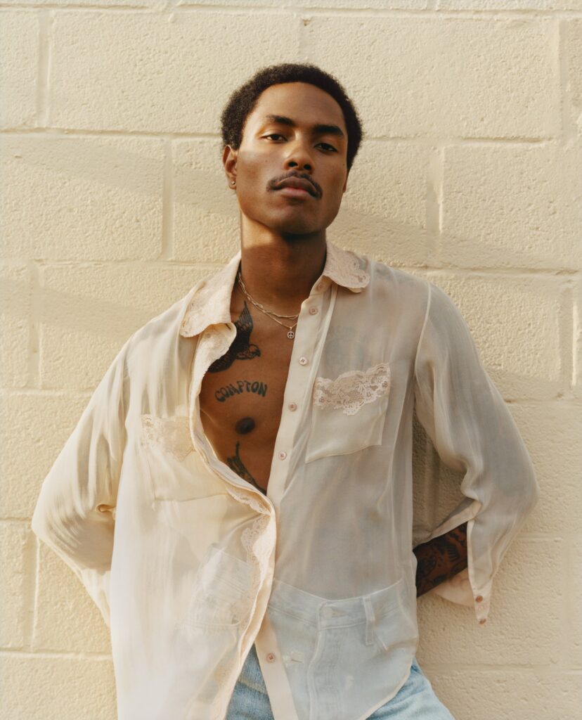 Steve Lacy standing in a white shirt.