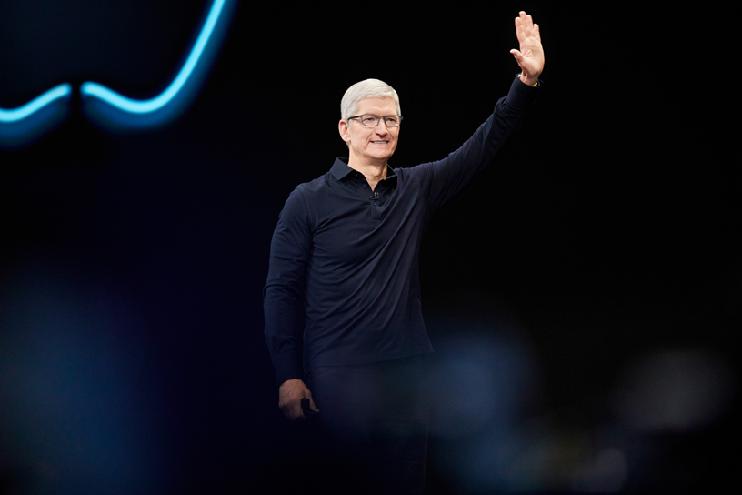 Tim Cook waving in a black shirt at WWDC conference 